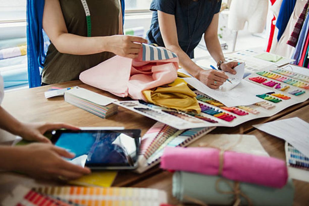 Garments designer choosing the expected fabric